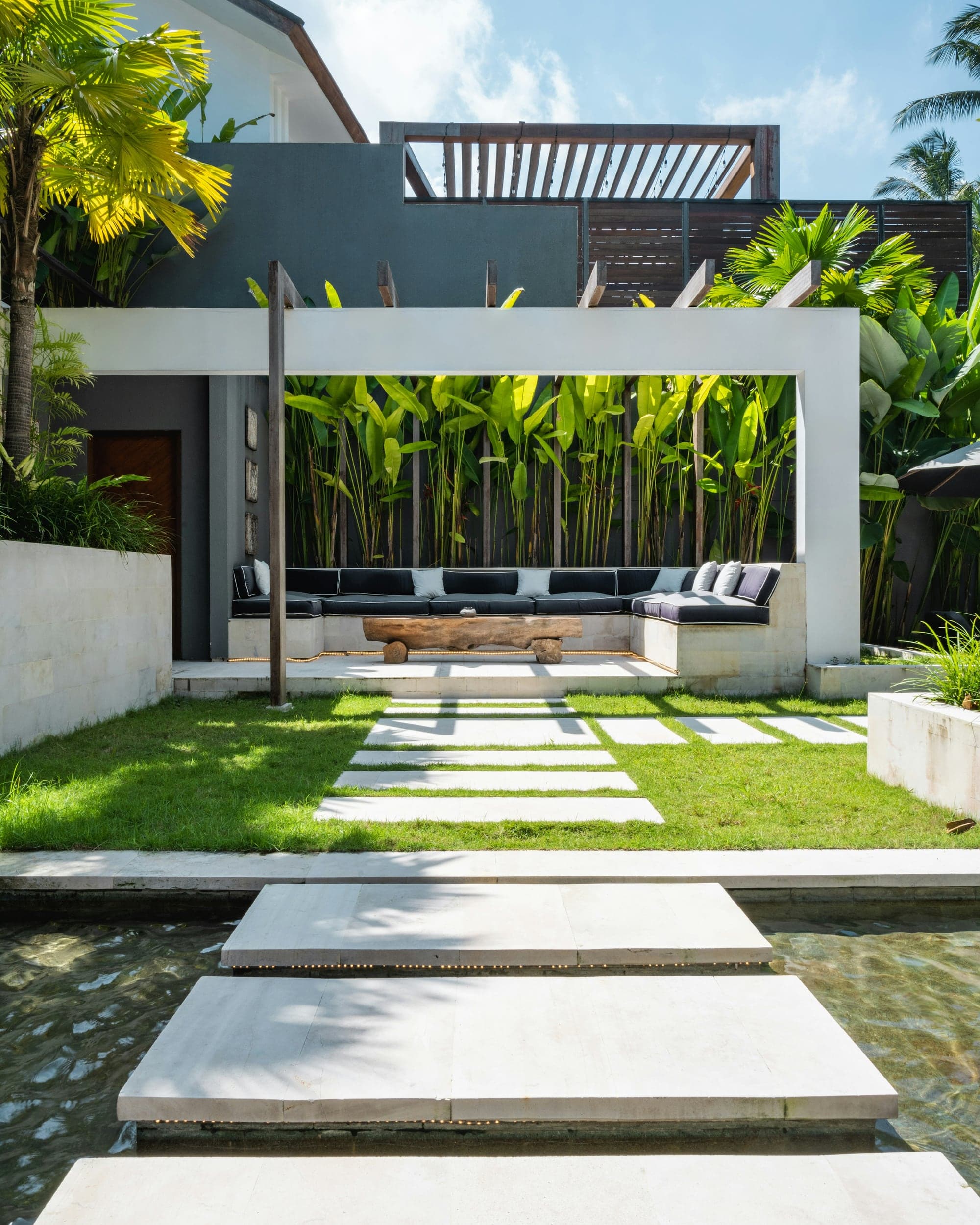 Studio Tanah, garden terrace under a white concrete frame, the opening photograph of the site