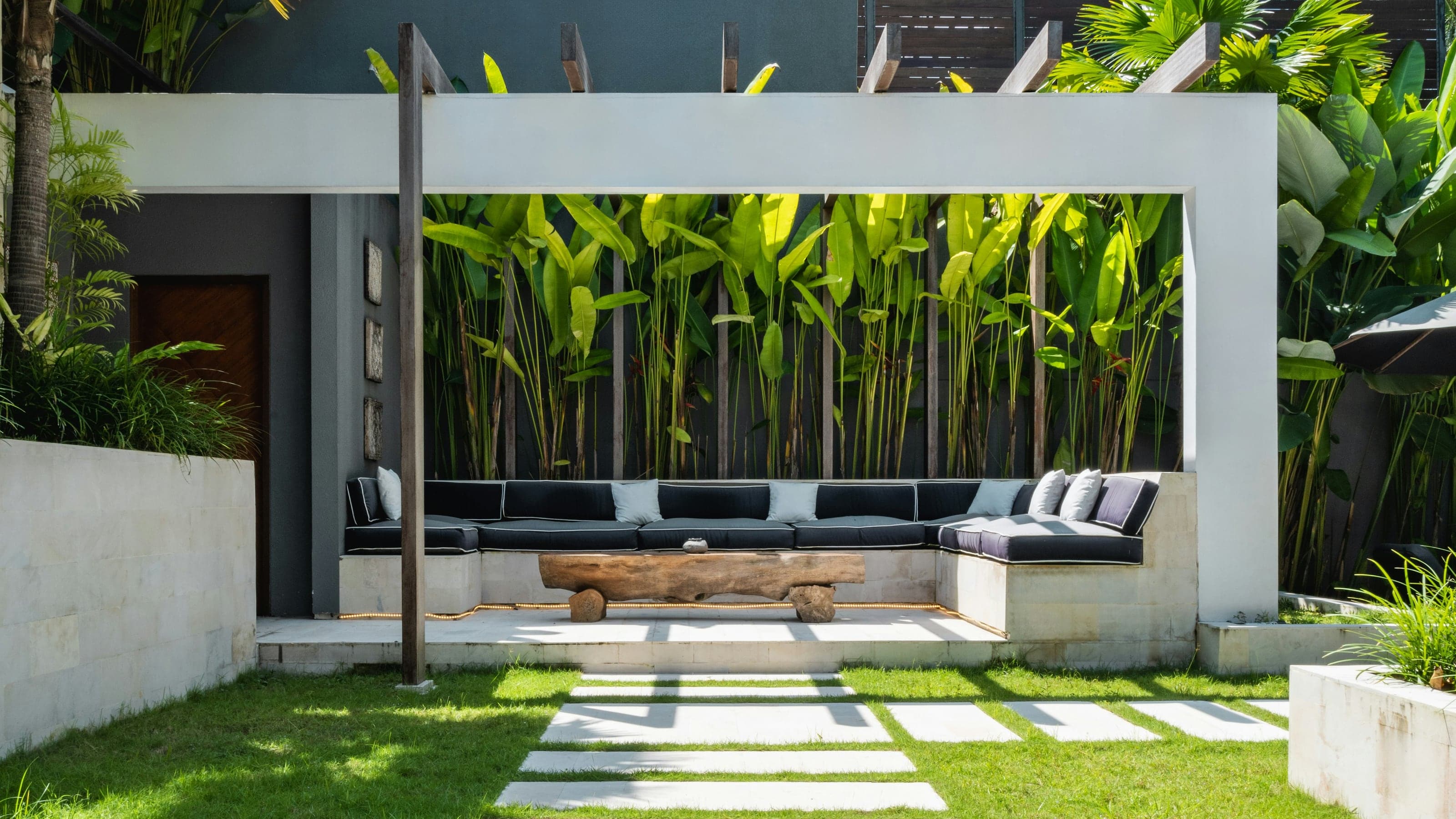 Studio Tanah, garden terrace under a white concrete frame, the opening photograph of the site